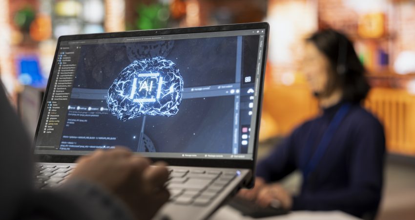 Digital Marketing Executive AI tech on laptop to reply to customers, closeup